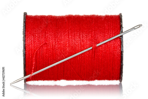 Spool of red thread with needle