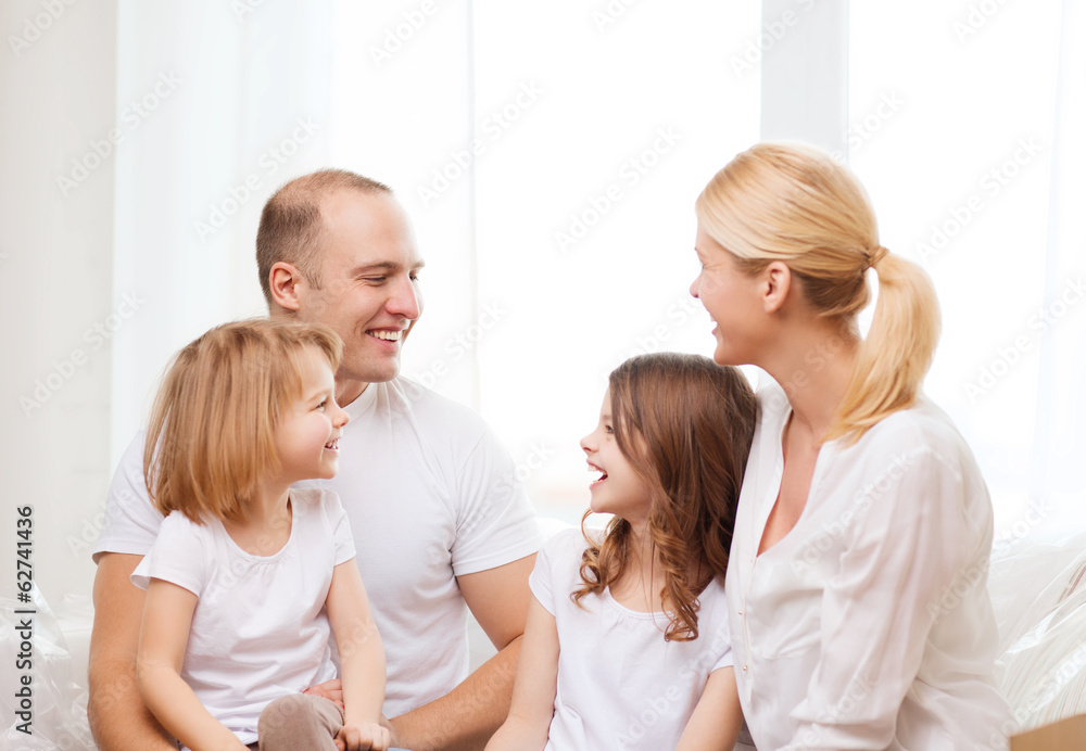 smiling family with two little girls at home smiling family with two little girls at home