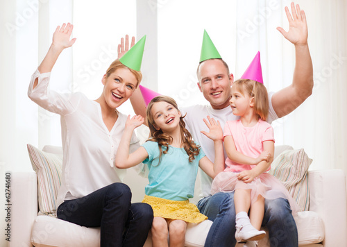 happy family with two kids in hats celebrating