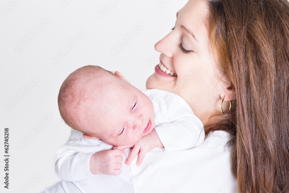 Young beautiful mother holding her newborn baby Young beautiful mother holding her newborn baby