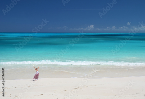 Girl on the desrt beach of Little Exuma, Bahamas