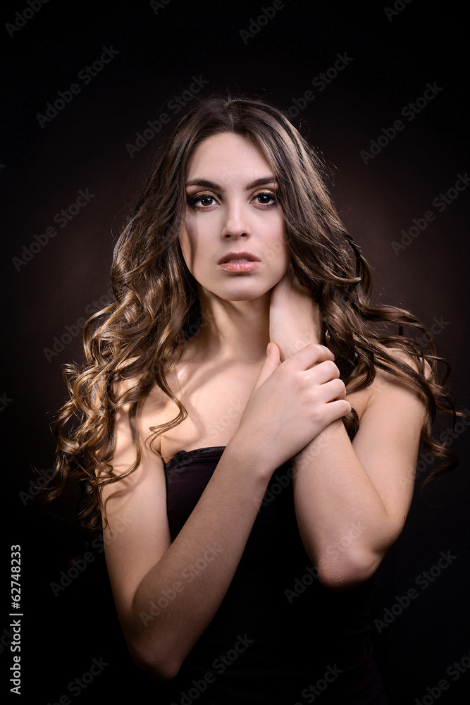 Beautiful young woman with long hair on dark brown background Beautiful young woman with long hair on dark brown background