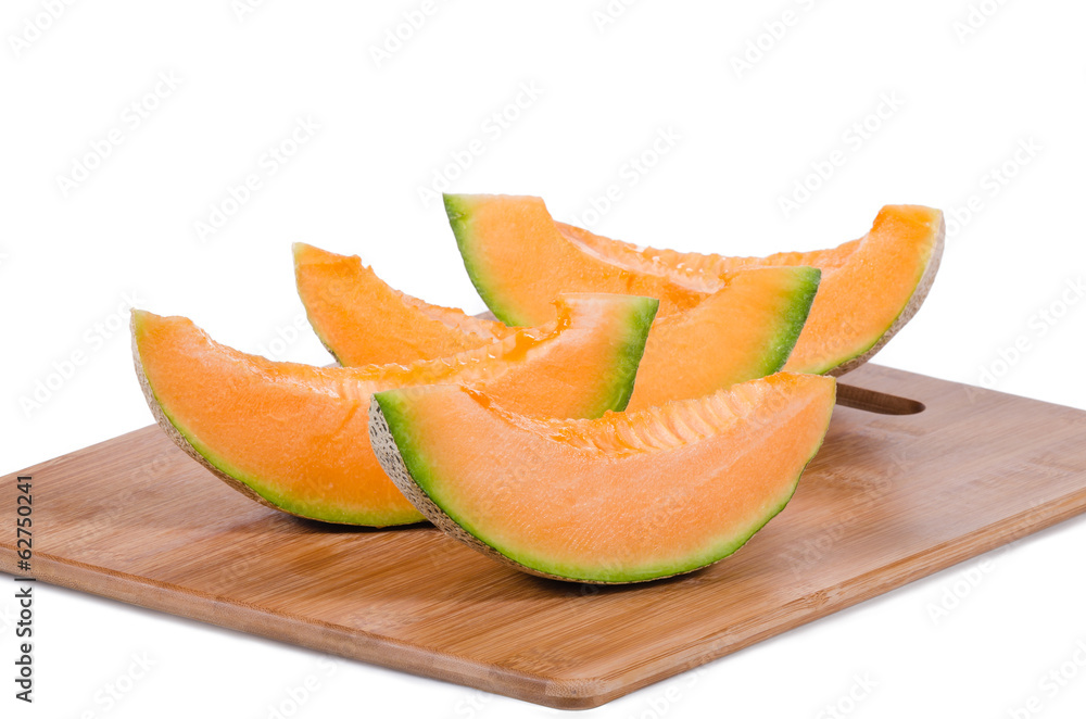 Cantaloupe melon slices on wooden cutting board Cantaloupe melon slices on wooden cutting board