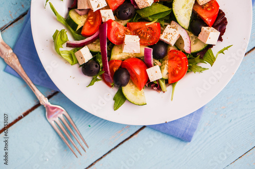 Greek salad on wooden background