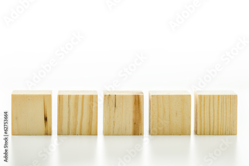 Row of five blank wooden blocks on a white background