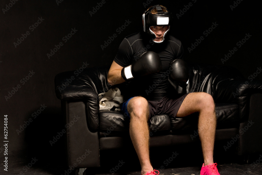 Boxer sitting on a couch getting ready for a fight