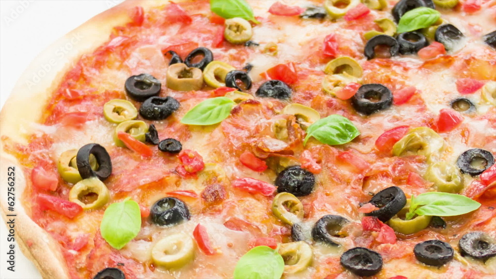 Beautiful multi colored and crispy pizza with basil and cheese Beautiful multi colored and crispy pizza with basil and cheese