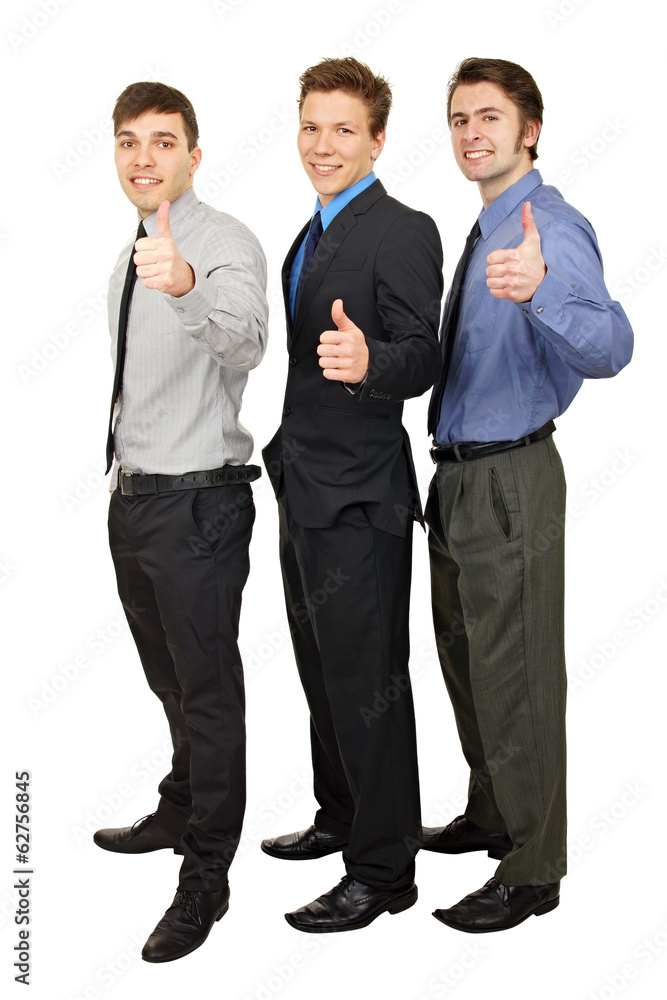 Three young business people standing shows you thumbs up Three young business people standing shows you thumbs up