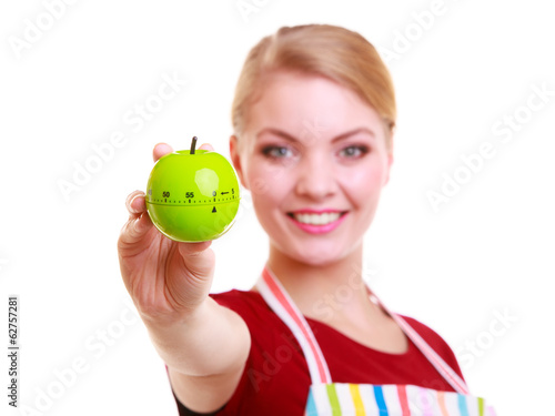 Happy housewife or chef in kitchen apron showing apple timer photo