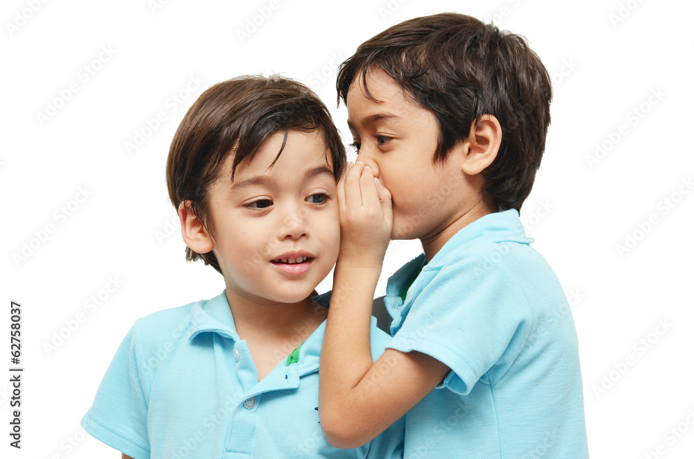 Little sibling boys sharing a secret on white background Little sibling boys sharing a secret on white background