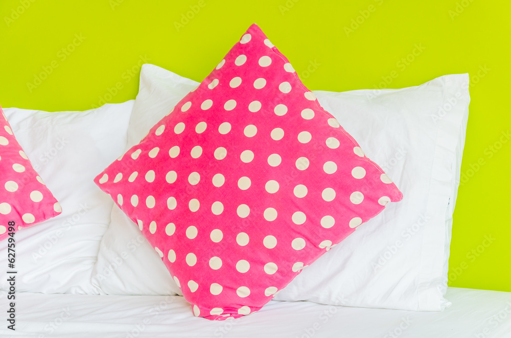Colorful polka pillow on white bed Colorful polka pillow on white bed