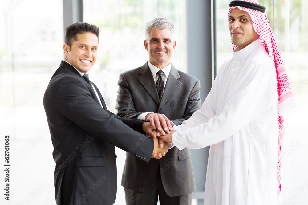 business team putting their hands on top of each other business team putting their hands on top of each other