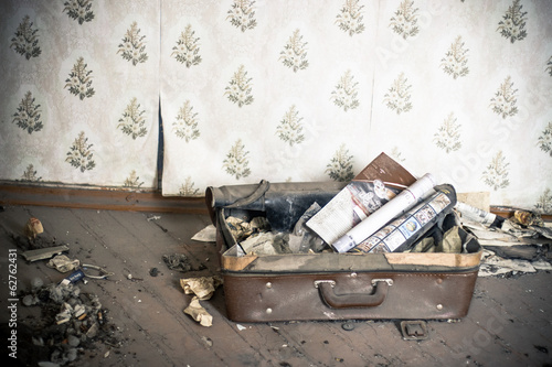 Old suitcase in abandoned room