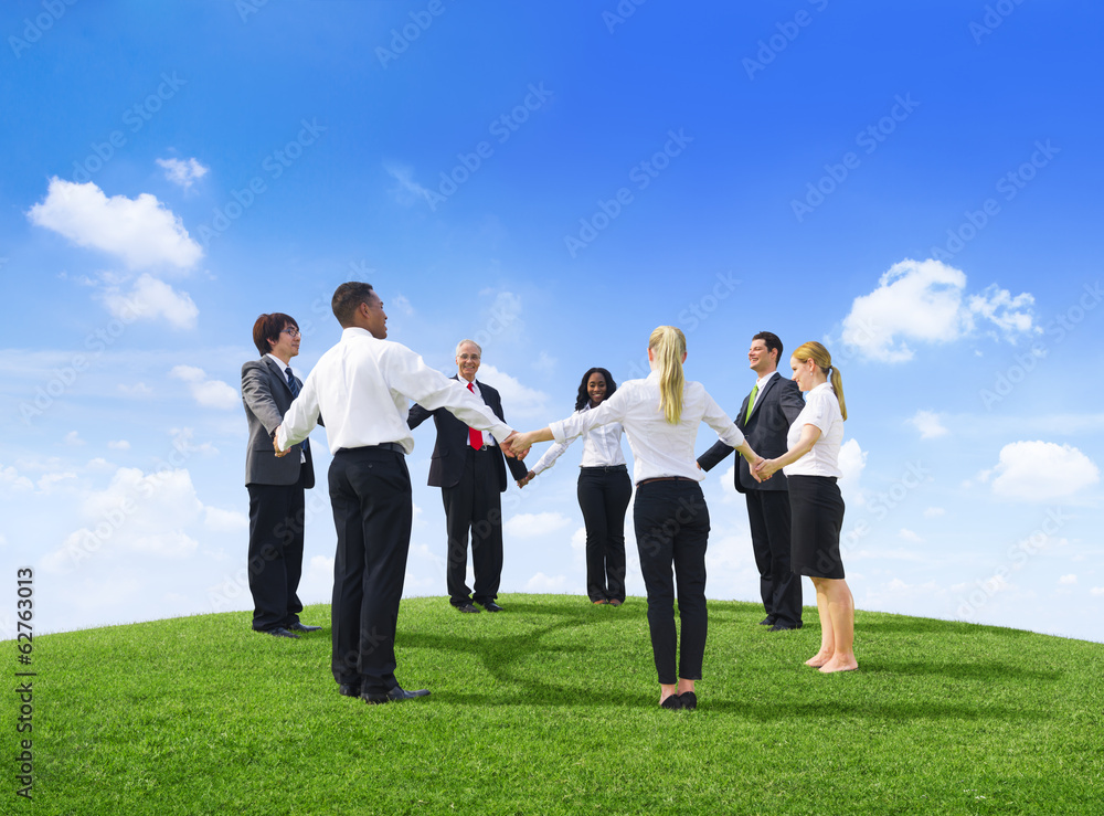 Business People Holding Hands On a Hill Business People Holding Hands On a Hill
