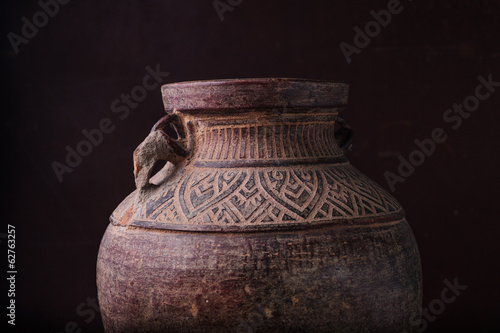 Earthenware jug standing on dark room © wildarun