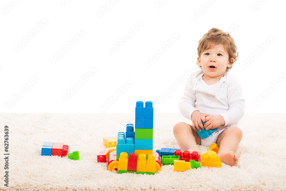 Happy boy playing with building blocks Happy boy playing with building blocks