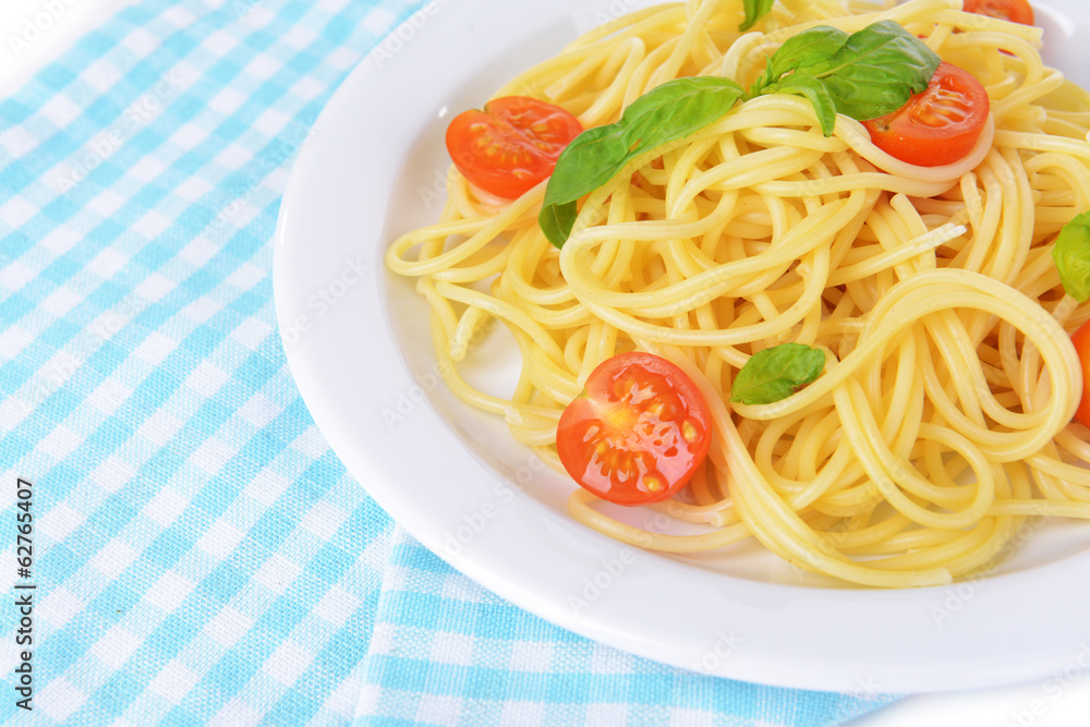 Delicious spaghetti with tomatoes on plate on table close-up Delicious spaghetti with tomatoes on plate on table close-up