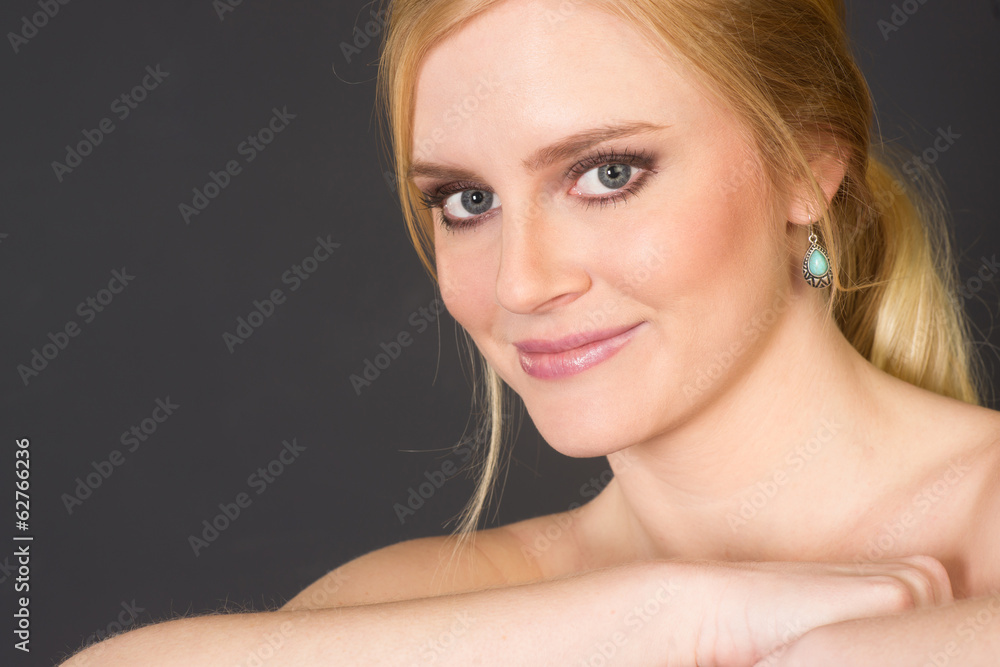Fototapeta premium Beautiful Blond Smiling Big in Head and Shoulders Beauty Pose