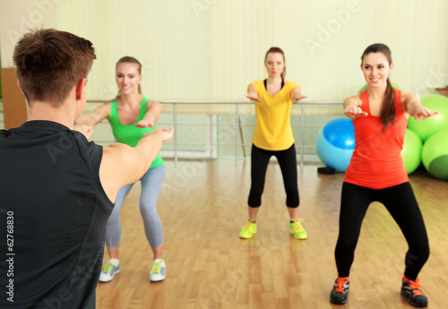 Young beautiful peoples engaged in gym