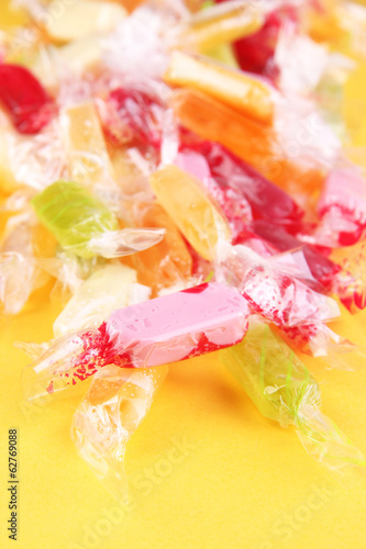 Fototapeta Naklejka Na Ścianę i Meble -  Tasty candies on yellow background