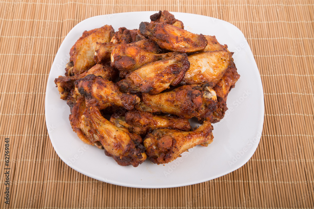 Mesquite Barbecue Chicken Wings on White Plate and Bamboo Mat Mesquite Barbecue Chicken Wings on White Plate and Bamboo Mat