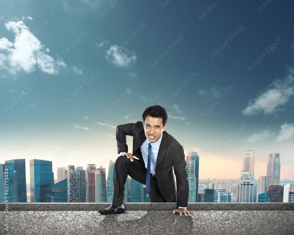 businessman climbing to the top of the building