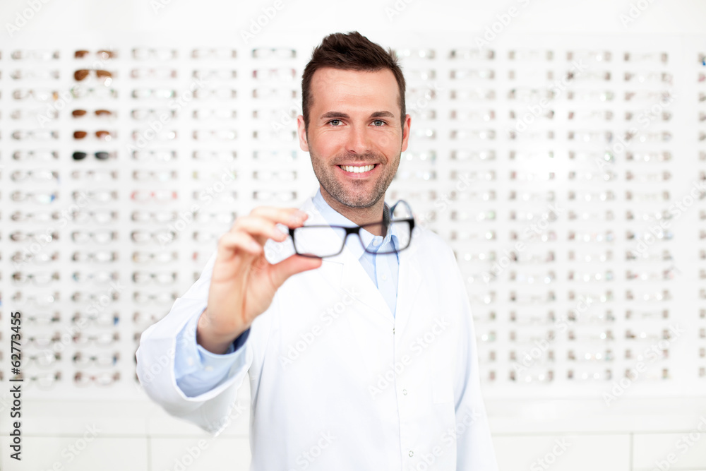 Happy optometrist, optician showing glasses Happy optometrist, optician showing glasses
