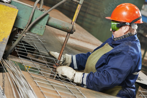 industry worker at spot welding machine photo