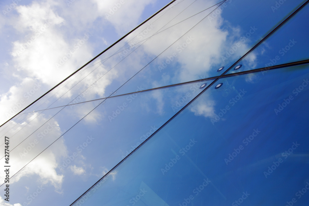 reflections of clouds in modern glass building reflections of clouds in modern glass building
