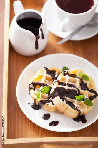 Belgian waffles with chocolate and powder sugar for breakfast