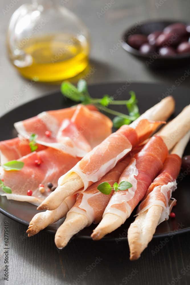prosciutto ham and grissini bread sticks. italian antipasto prosciutto ham and grissini bread sticks. italian antipasto
