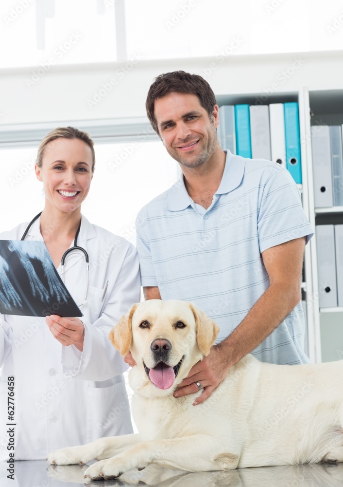 Pet owner and vet with Xray of dog Pet owner and vet with Xray of dog