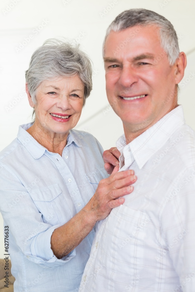 Smiling retired couple looking at camera Smiling retired couple looking at camera