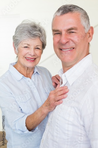 Smiling retired couple looking at camera