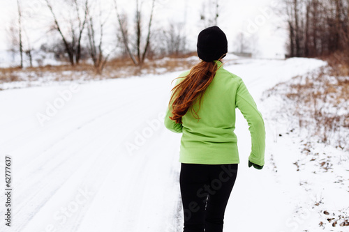 Woman running in winter snow