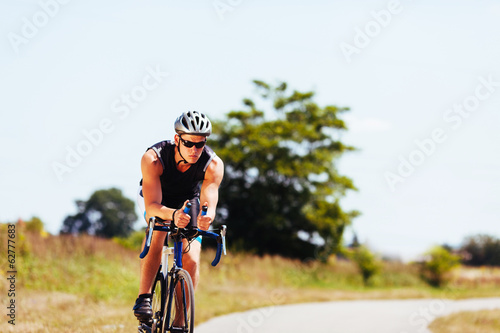 Fototapeta Naklejka Na Ścianę i Meble -  Triathlete cycling on a bicycle