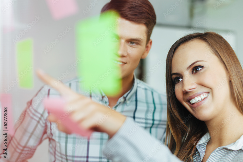Two happy employees working together in the office Two happy employees working together in the office