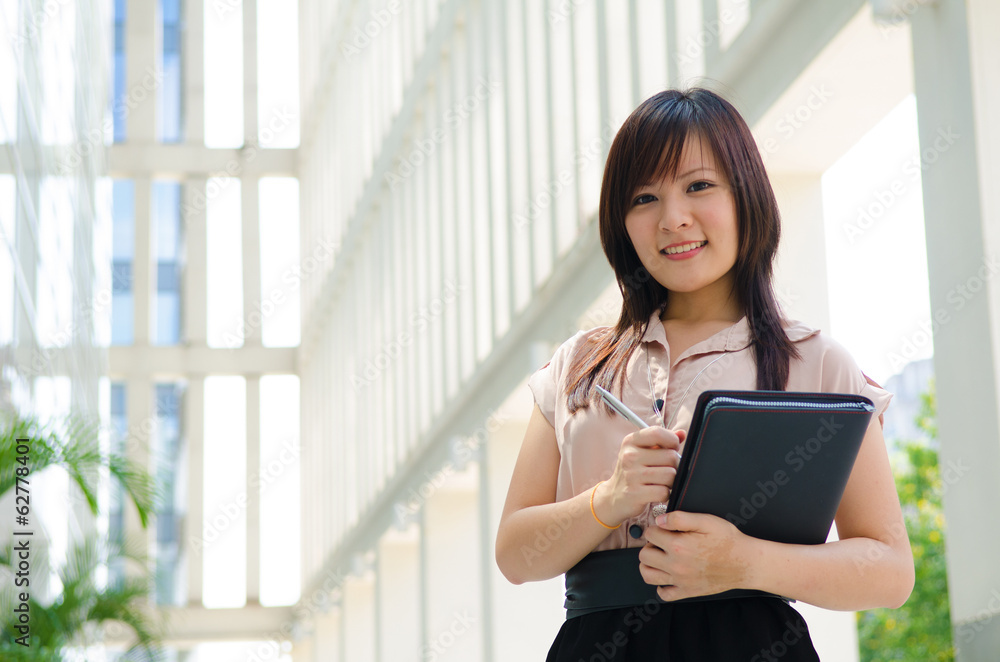 young asian business woman with office background