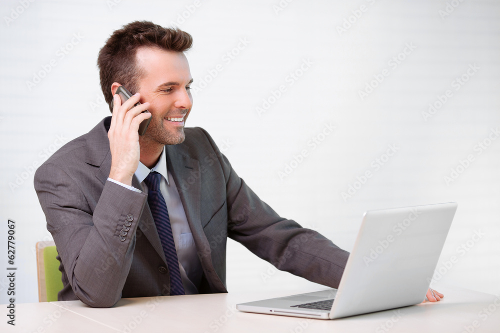 Manager talking on the phone in the office Manager talking on the phone in the office