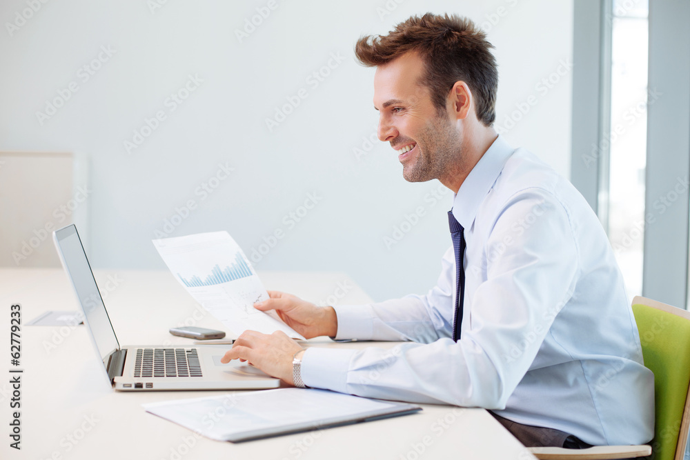 Man analyzing financial data in the office Man analyzing financial data in the office