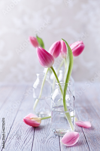 Fototapeta Naklejka Na Ścianę i Meble -  Spring Tulips in Glass Bottles