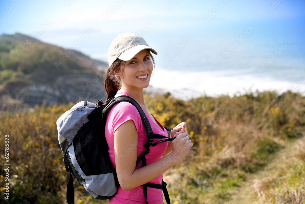Brunette girl on a hiking day with backpack