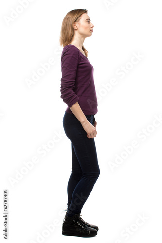 Thoughtful young woman standing sideways