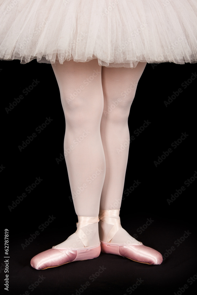 Ballet dancer standing on black floor while dancing artistic con Ballet dancer standing on black floor while dancing artistic con