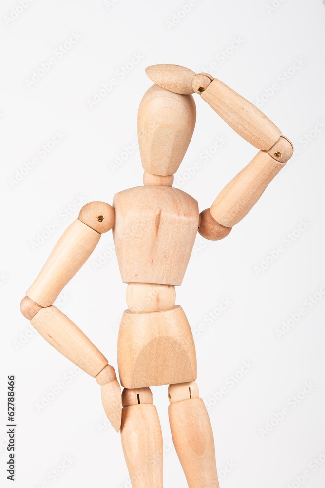 Plain wood mannequin stand upright isolated on white holding hea Plain wood mannequin stand upright isolated on white holding hea