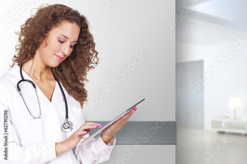 young and beautiful woman holding a portable computer