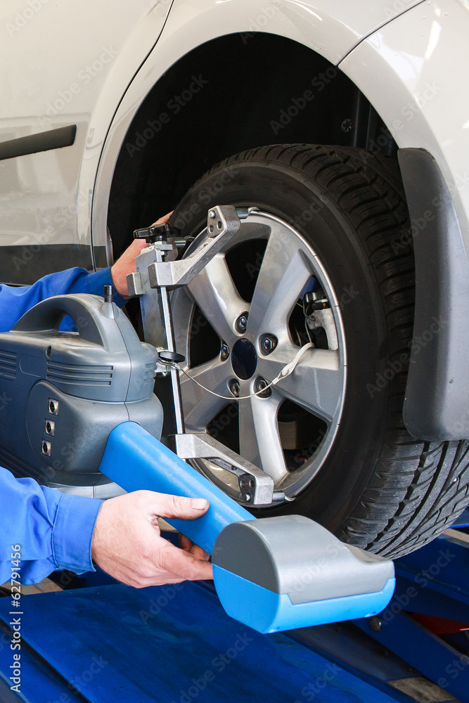 Fragment of car tyre during diagnostic testing and adjusting  to