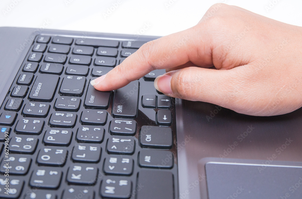 Closeup woman hand touch enter key Closeup woman hand touch enter key