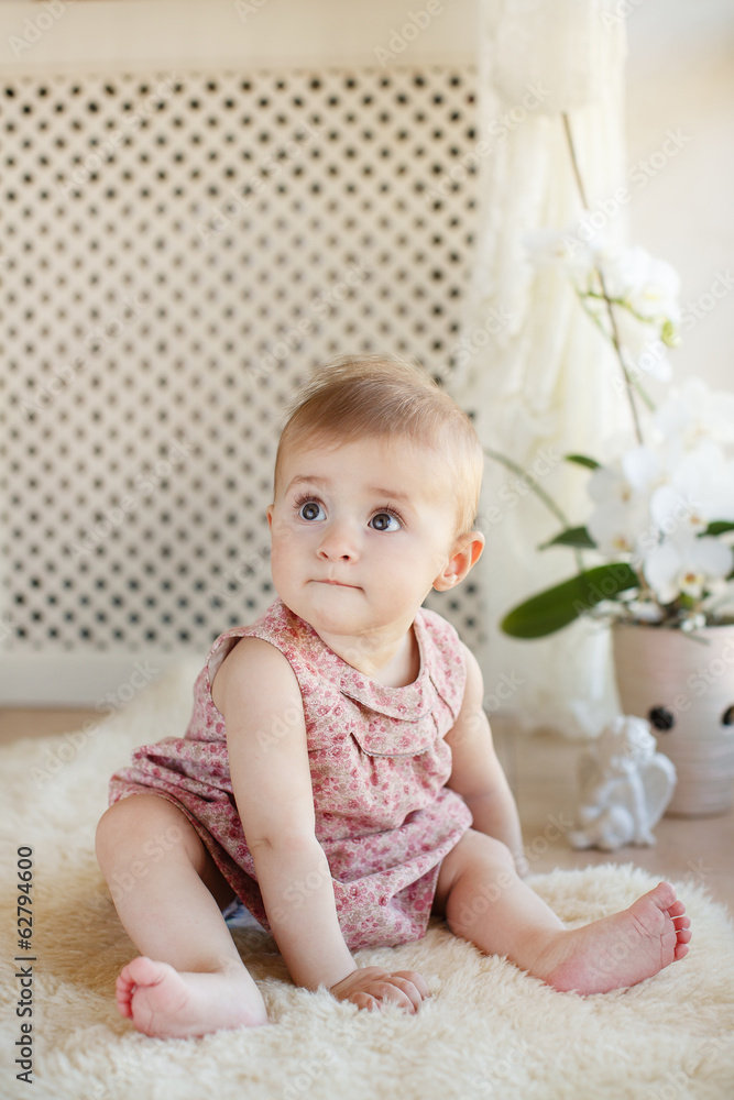 portrait of pretty smiling baby girl sitting on the floor portrait of pretty smiling baby girl sitting on the floor