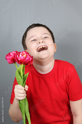 Boy with a bouquet of red tulips